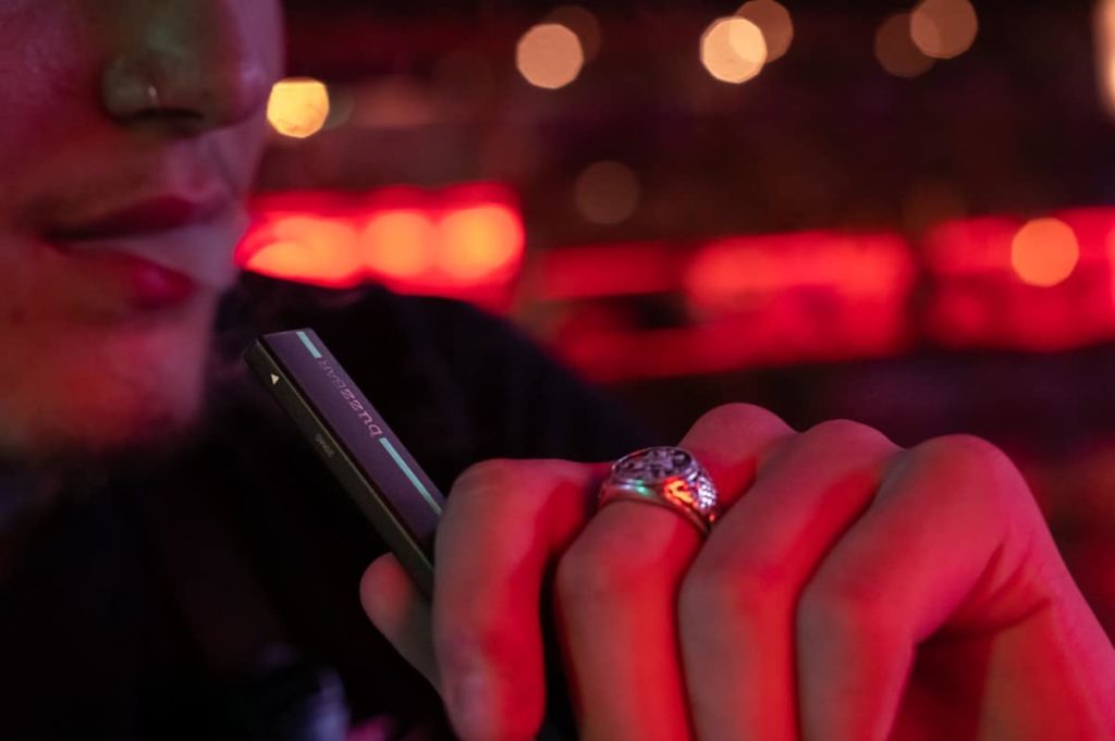 buzz bar disposable vape being vaped in red room