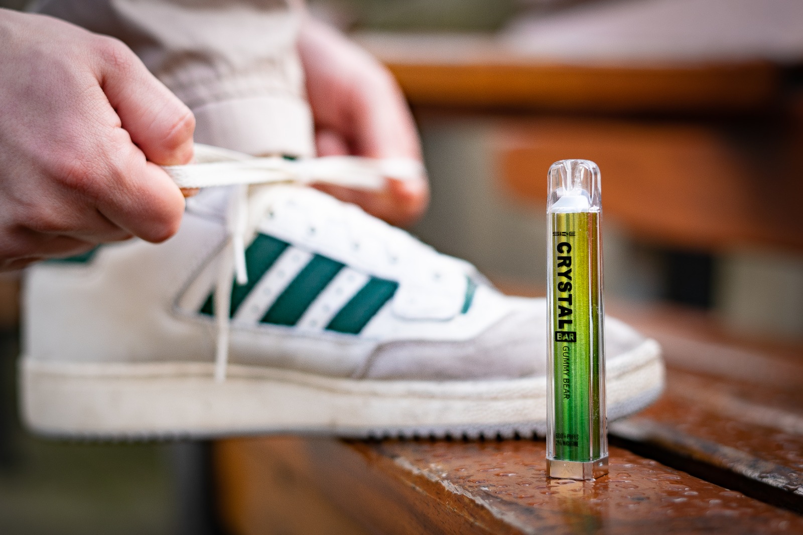 crystal bar disposable vape in front of adidas shoes