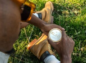what are nicotine pouches? man holding nic pouches sat on grass
