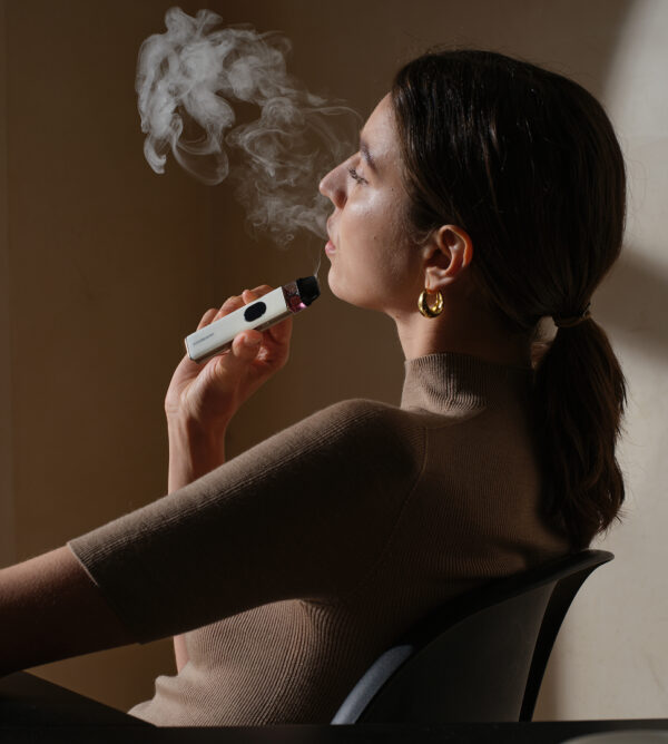 Woman Vaping on Vaporesso XROS 5 Reffilable Vape Kit